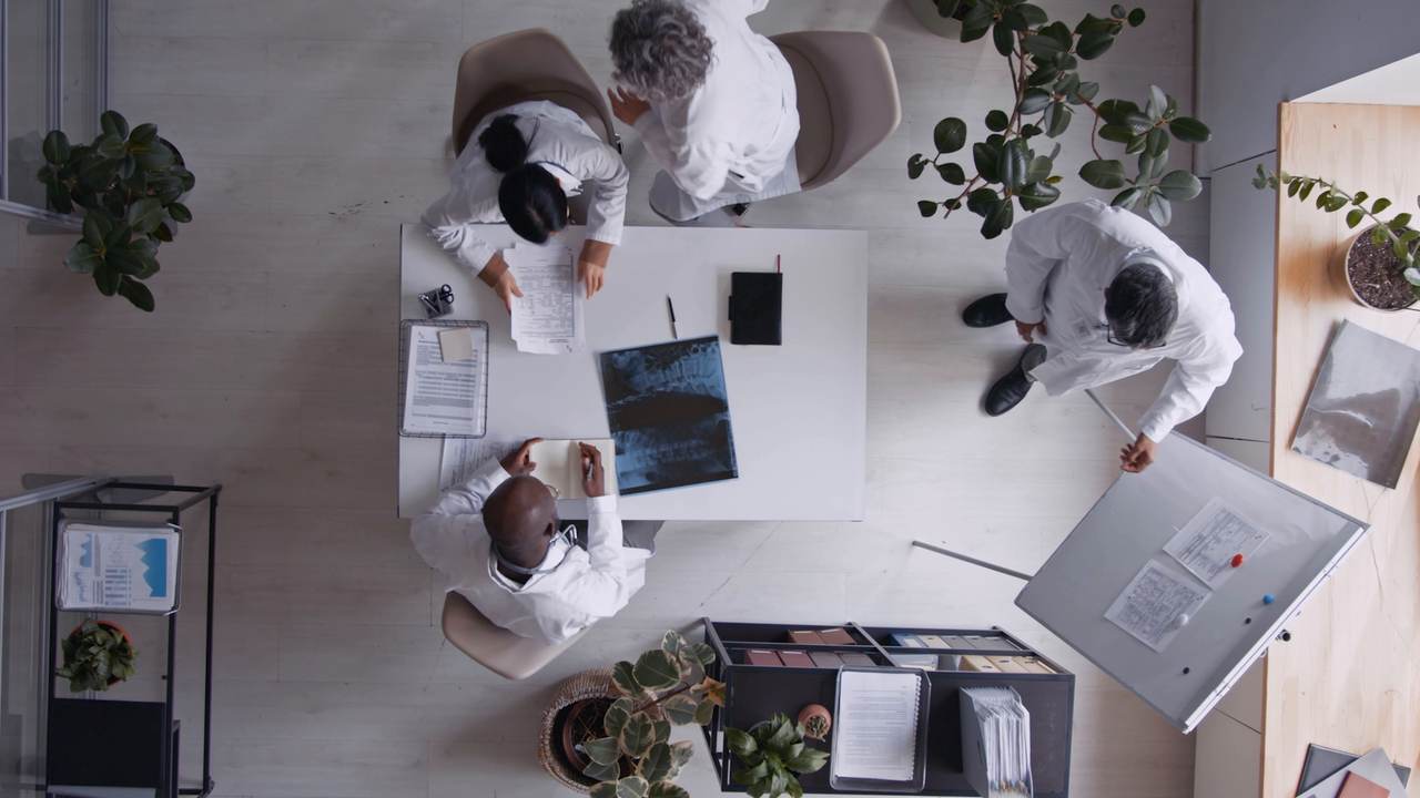 Overhead view of the team meeting around a table